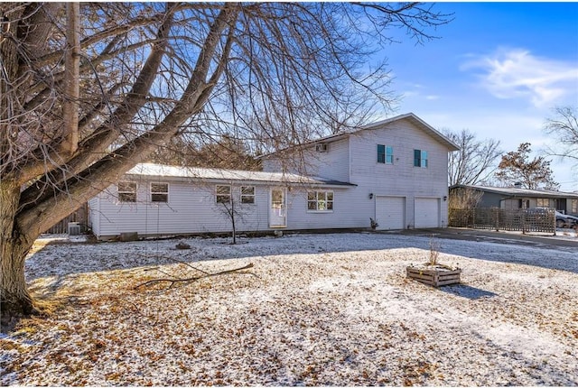 rear view of house featuring a garage