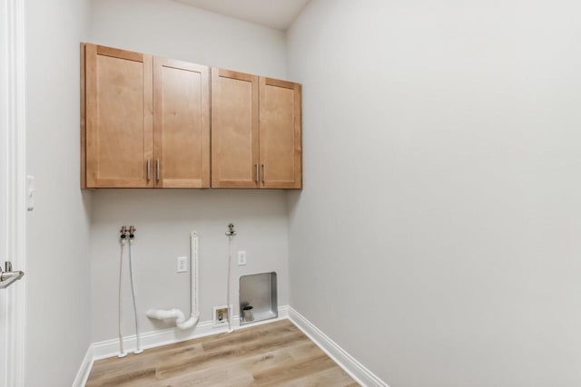 laundry area featuring cabinets, light wood-type flooring, and hookup for a washing machine