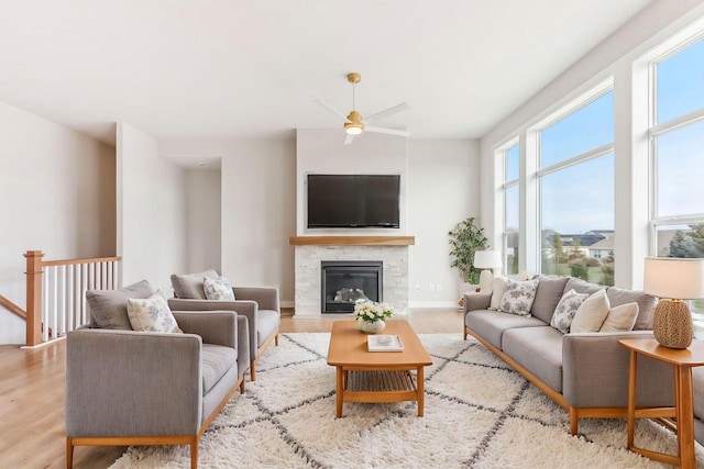 living room with light hardwood / wood-style flooring and ceiling fan