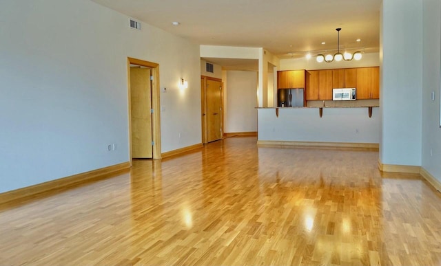 unfurnished living room featuring light hardwood / wood-style floors