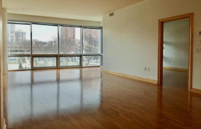 unfurnished room featuring hardwood / wood-style flooring