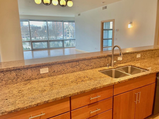 kitchen featuring light stone countertops and sink