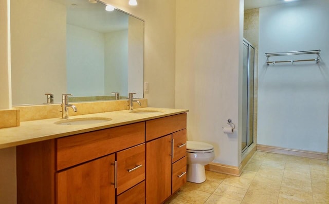 bathroom with tile patterned flooring, vanity, toilet, and an enclosed shower