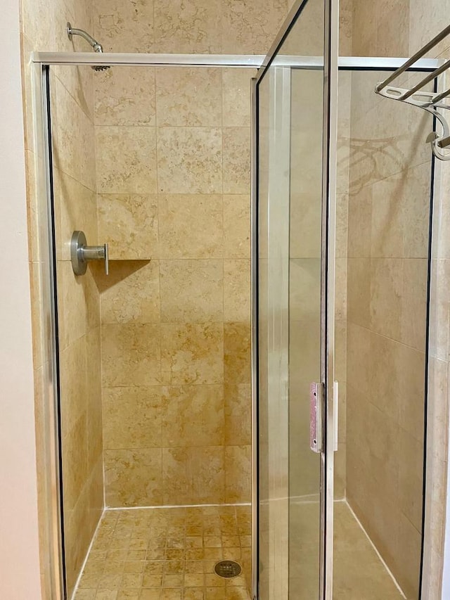 bathroom with a shower with door