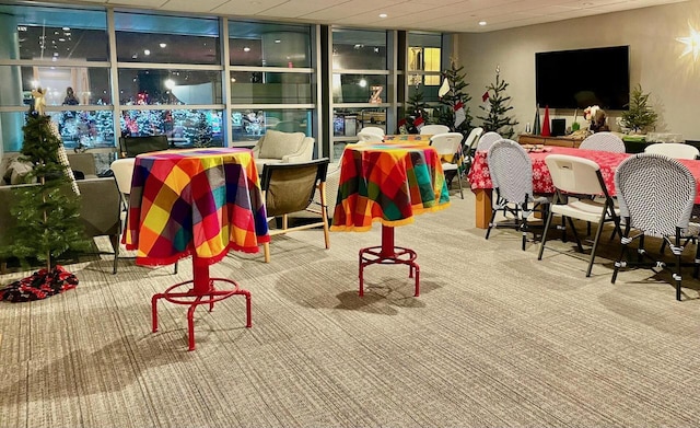 interior space featuring carpet flooring and floor to ceiling windows