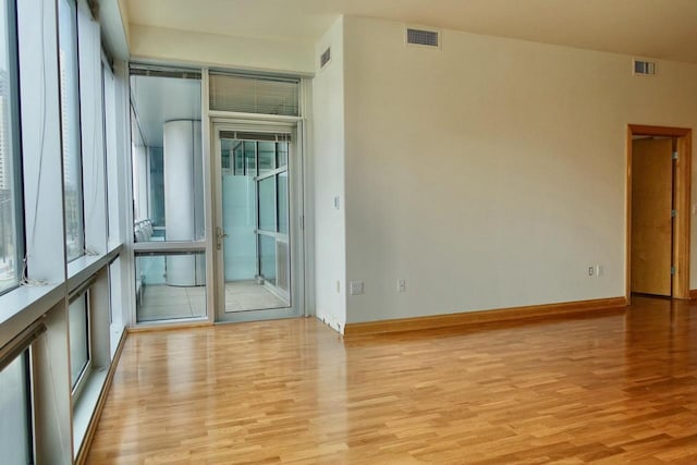 empty room with light hardwood / wood-style floors