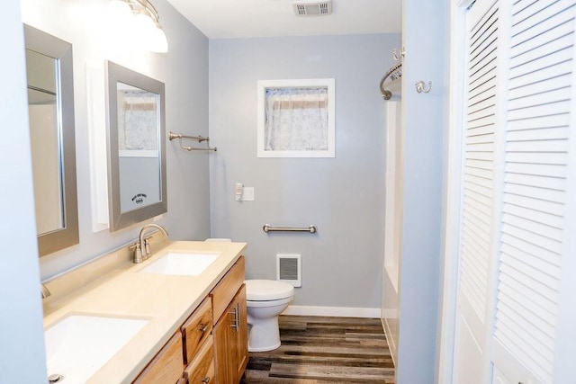 bathroom featuring hardwood / wood-style floors, vanity, and toilet