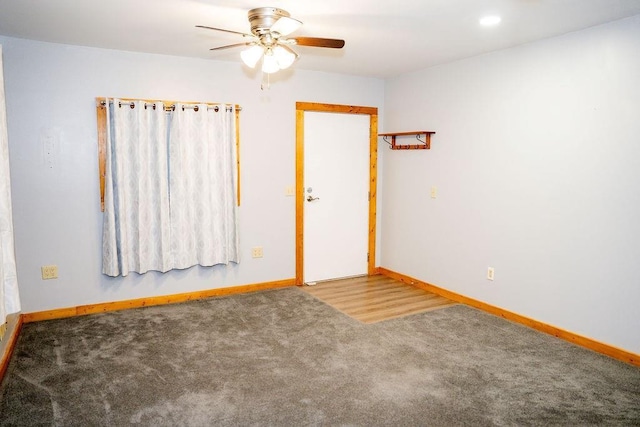 spare room with ceiling fan and carpet