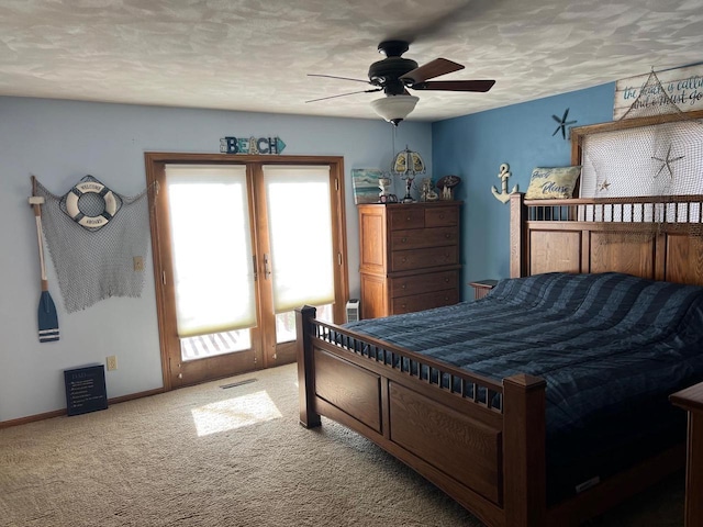 carpeted bedroom featuring a textured ceiling and ceiling fan