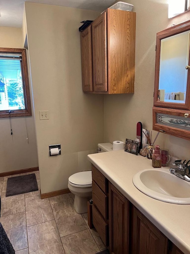 bathroom with tile patterned flooring, vanity, and toilet