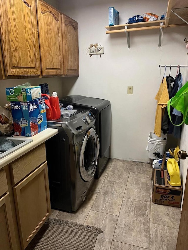 washroom with cabinets and washer and clothes dryer