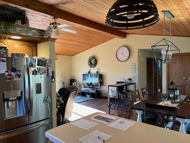 dining room with ceiling fan with notable chandelier, hardwood / wood-style floors, vaulted ceiling with beams, and wooden ceiling