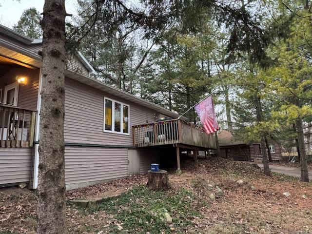 view of side of property featuring a wooden deck