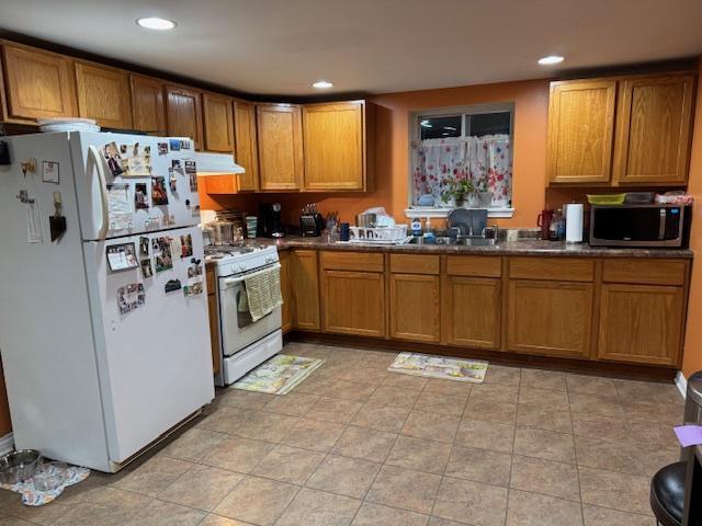 kitchen featuring sink and white appliances