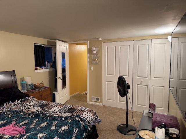 bedroom featuring light colored carpet