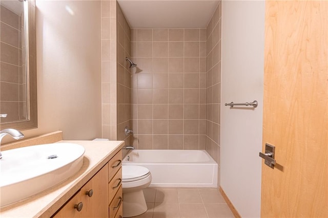 full bathroom featuring tile patterned flooring, vanity, toilet, and tiled shower / bath combo