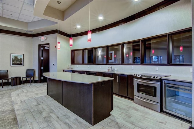 kitchen with a center island, sink, light hardwood / wood-style flooring, pendant lighting, and stainless steel range with electric cooktop