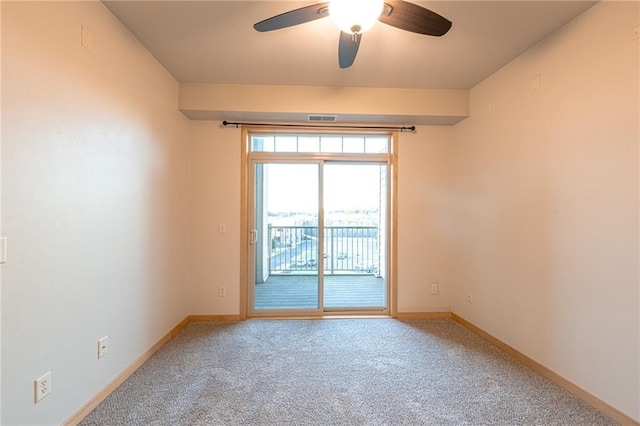 spare room with ceiling fan and carpet