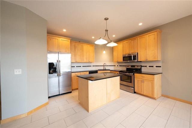 kitchen with appliances with stainless steel finishes, a kitchen island, light brown cabinetry, and sink