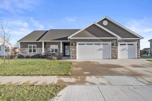 craftsman-style home with a garage and a front lawn