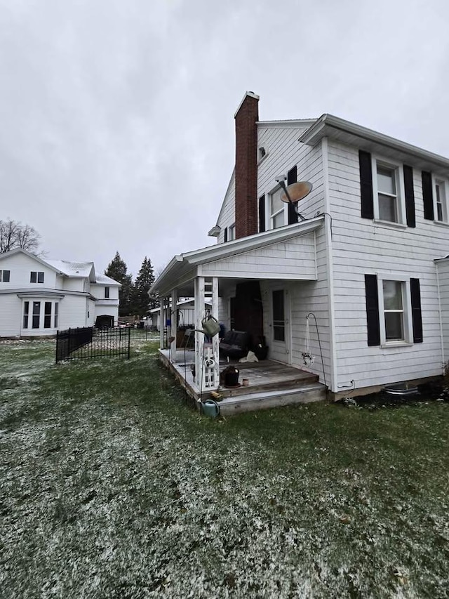 rear view of property featuring a yard