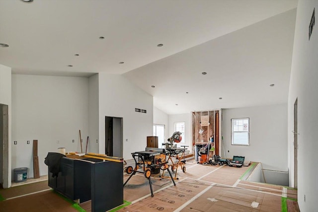 living room featuring high vaulted ceiling