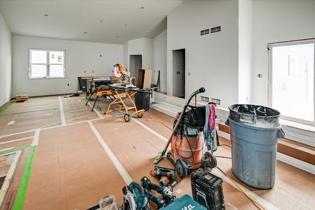 interior space with hardwood / wood-style flooring and high vaulted ceiling