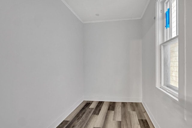 spare room featuring hardwood / wood-style flooring and crown molding