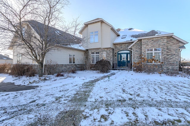 view of snow covered back of property