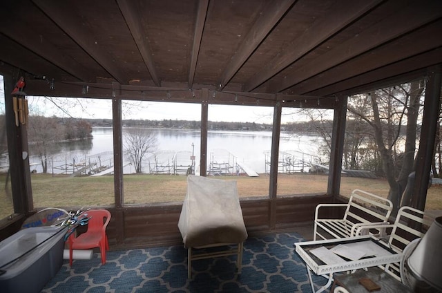 sunroom / solarium featuring plenty of natural light and a water view