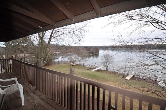 wooden deck featuring a lawn and a water view