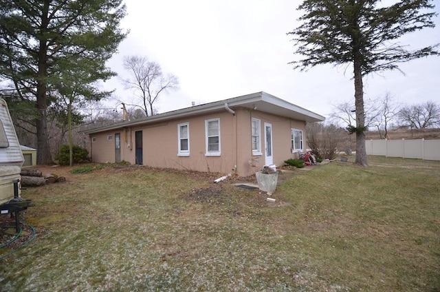 rear view of property with a lawn