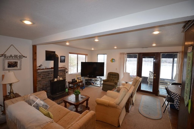 living room featuring hardwood / wood-style floors, a wood stove, and french doors