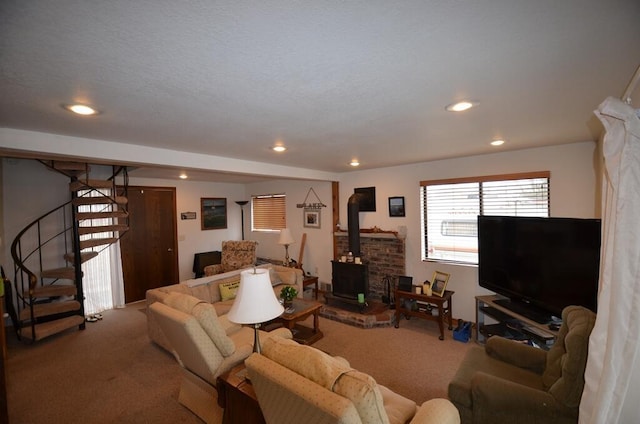 carpeted living room featuring a wood stove