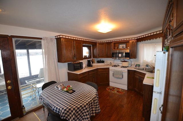 kitchen with white appliances, dark hardwood / wood-style floors, and sink