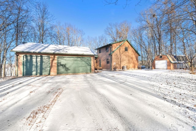 view of front of home with a garage and an outdoor structure