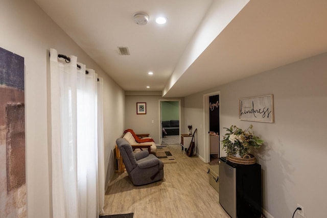 sitting room featuring light hardwood / wood-style floors