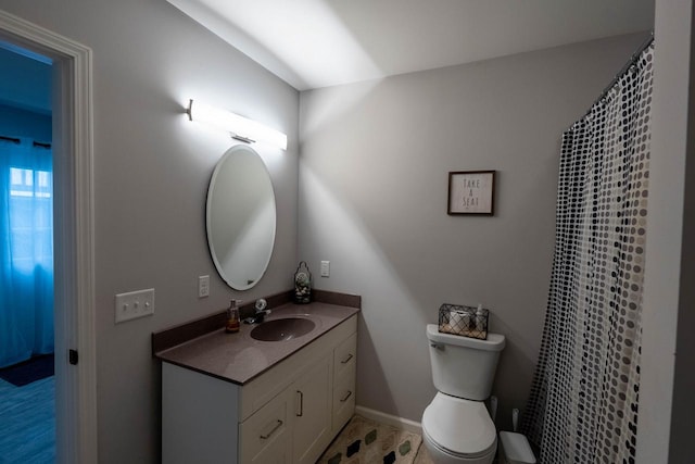 bathroom with hardwood / wood-style flooring, vanity, and toilet