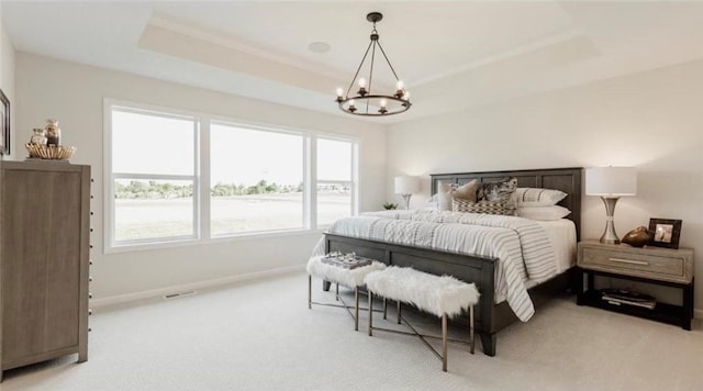 bedroom with baseboards, a raised ceiling, a notable chandelier, and light colored carpet