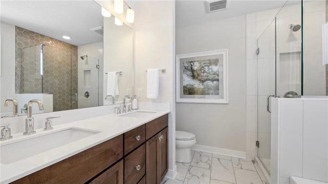 bathroom featuring marble finish floor, baseboards, visible vents, and a sink