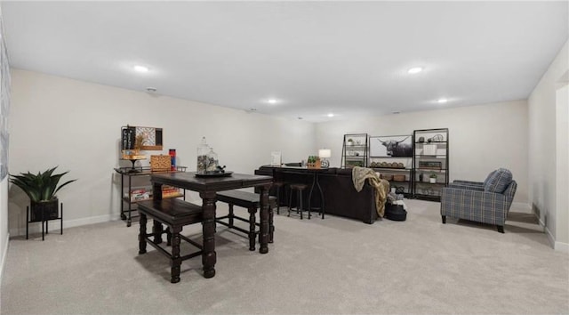 dining area featuring light carpet, baseboards, and recessed lighting