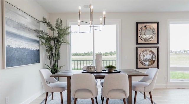 dining area featuring light hardwood / wood-style flooring and a chandelier