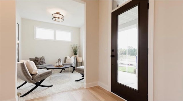 foyer entrance featuring light wood-style flooring and baseboards