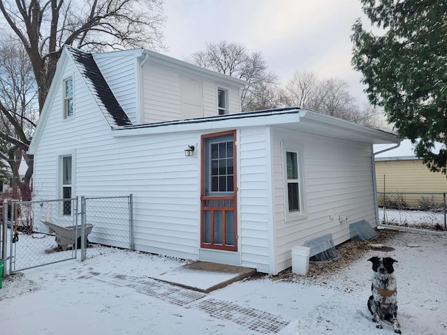 view of snow covered back of property