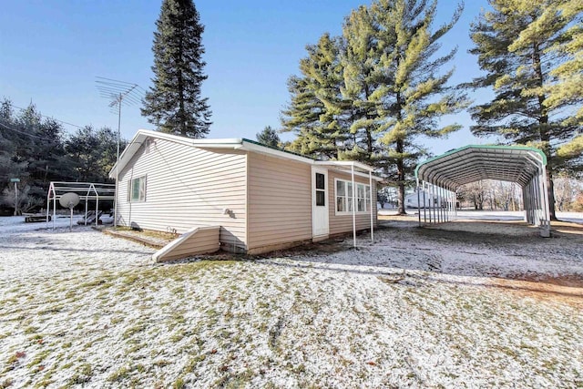 view of side of home with a carport