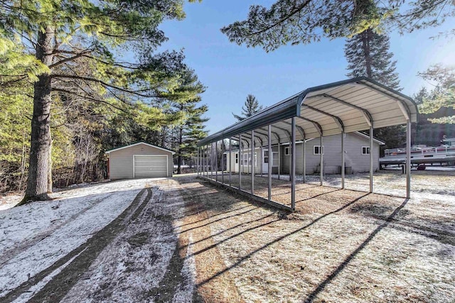 exterior space featuring a carport, a garage, and an outbuilding