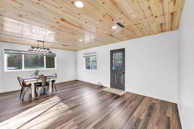 dining room with dark hardwood / wood-style floors, plenty of natural light, and wooden ceiling