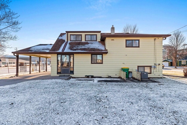 rear view of house featuring cooling unit