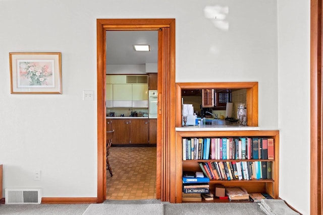 hall with carpet flooring