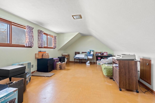 bonus room featuring a textured ceiling, a wealth of natural light, and vaulted ceiling